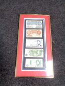 A frame containing five English bank notes