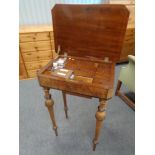 A 19th century walnut sewing table