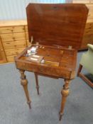A 19th century walnut sewing table