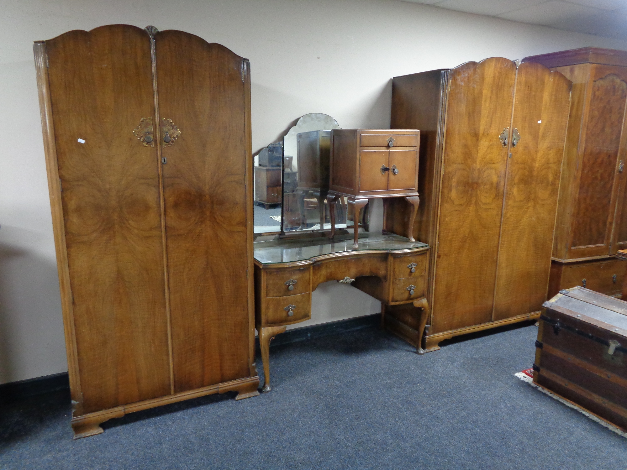 A 20th century four piece walnut bedroom suite comprising of lady's and gent's wardrobes,