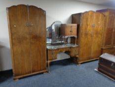 A 20th century four piece walnut bedroom suite comprising of lady's and gent's wardrobes,