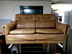 A mid 20th century Danish brown leather two seater settee