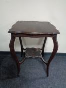 A shaped Edwardian two tier occasional table