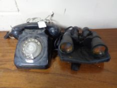 A black Bakelite telephone together with a set of Vivitar binoculars in case