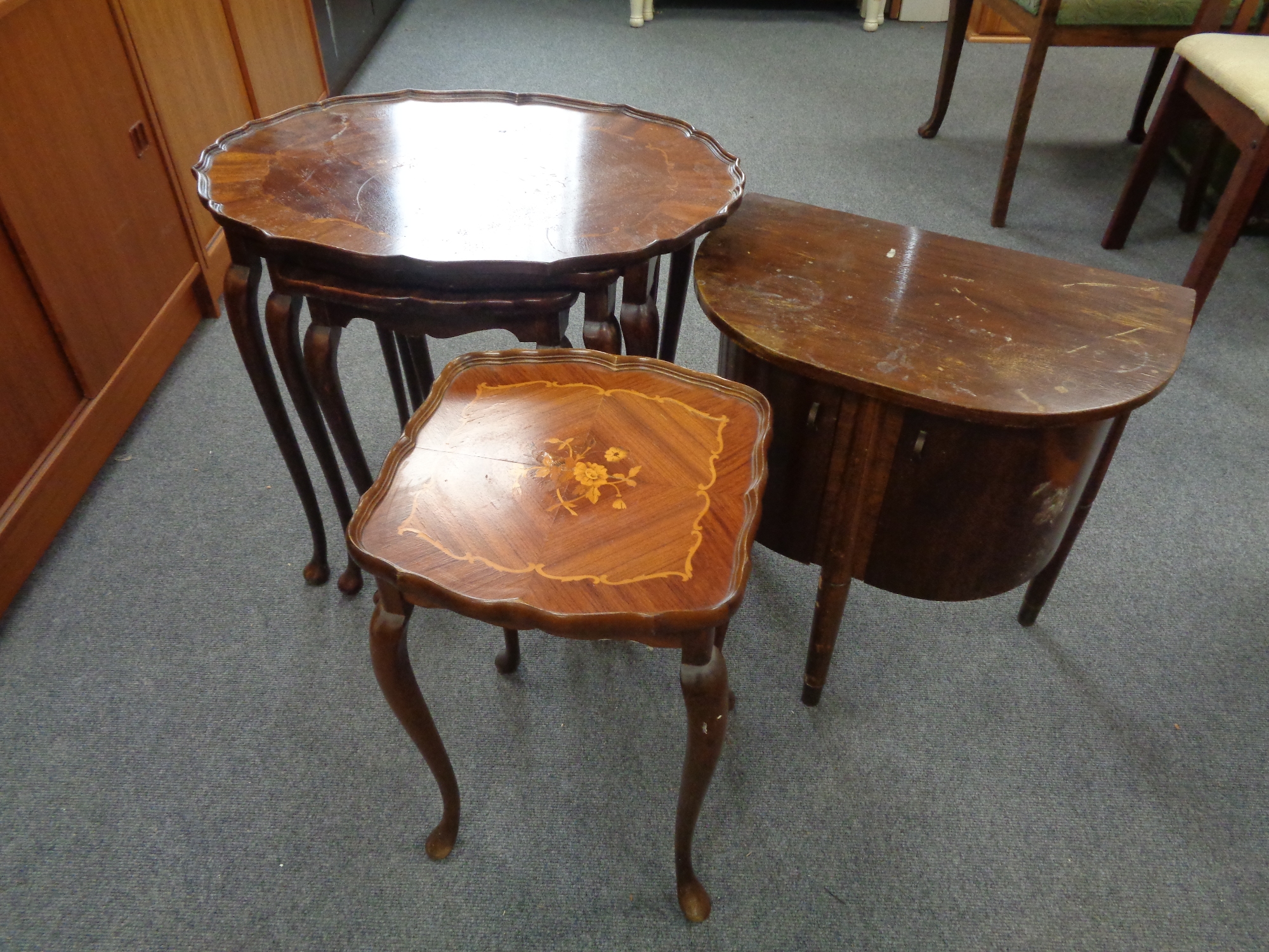 A nest of three walnut Italian style tables together with a matching lamp table and a D-shaped