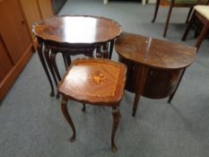 A nest of three walnut Italian style tables together with a matching lamp table and a D-shaped