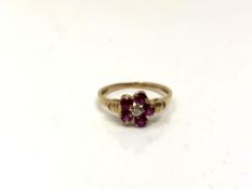 A 10ct gold ruby and diamond cluster ring, size N/O. CONDITION REPORT: 1.