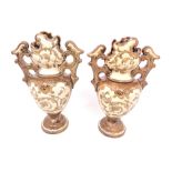 A pair of miniature continental pottery twin handled vases,