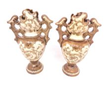 A pair of miniature continental pottery twin handled vases,