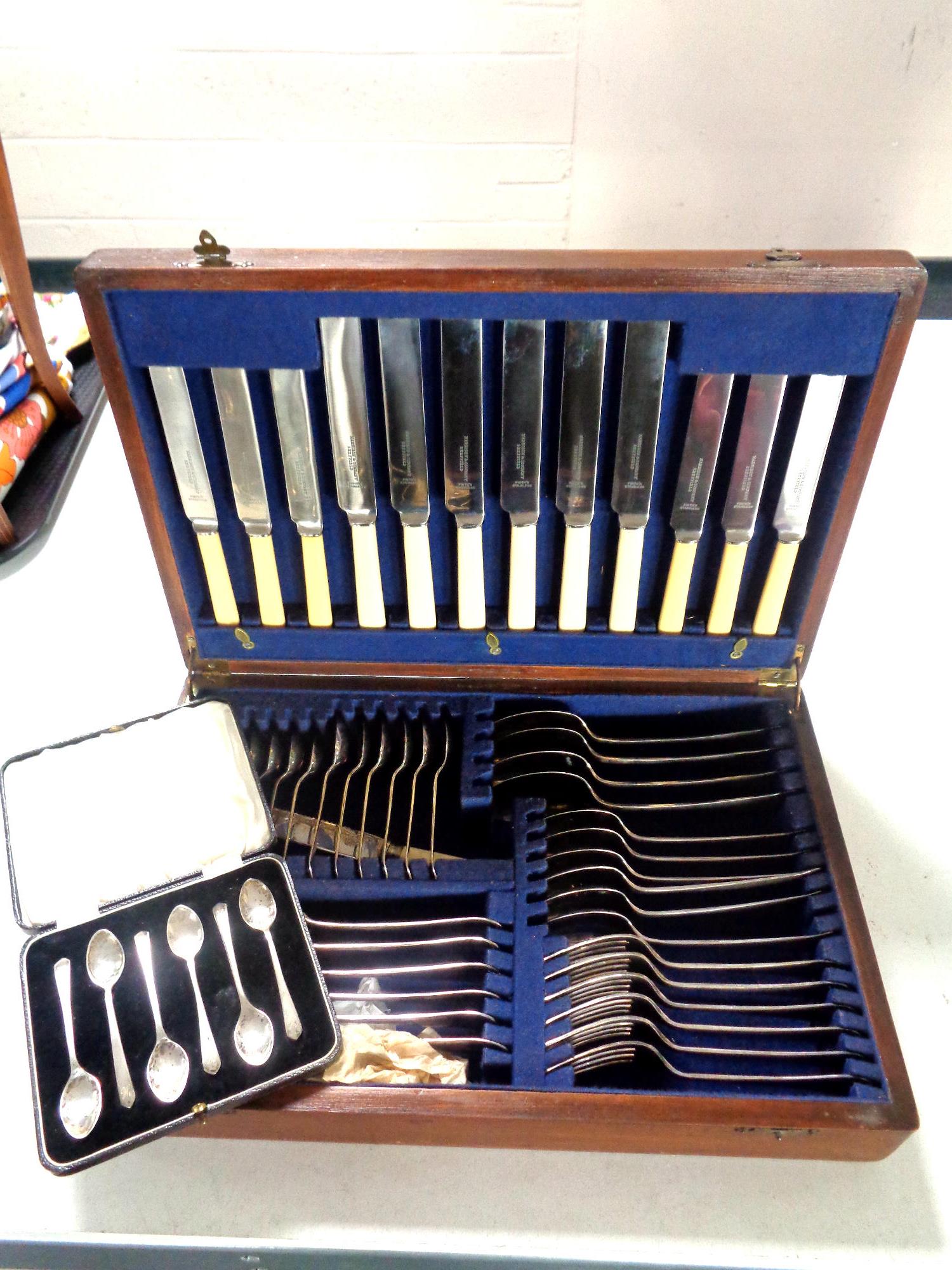 A canteen of plated and stainless steel cutlery together with a cased set of six white metal tea