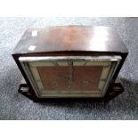 A 1930s oak cased continental mantel clock.