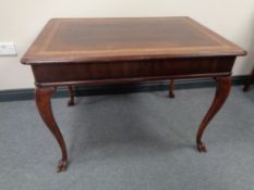 An antique mahogany centre table on cabriole legs