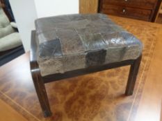 A 20th century stained beech leather upholstered footstool