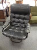 A 20th century black leather swivel relaxer armchair