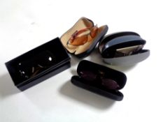 A box containing four pairs of branded sunglasses