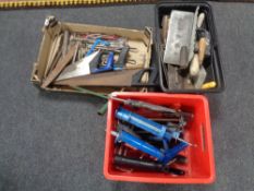 A box and two plastic crates containing assorted tools to include hand saws, files,