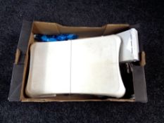 A box containing two Nintendo Wii's with leads,