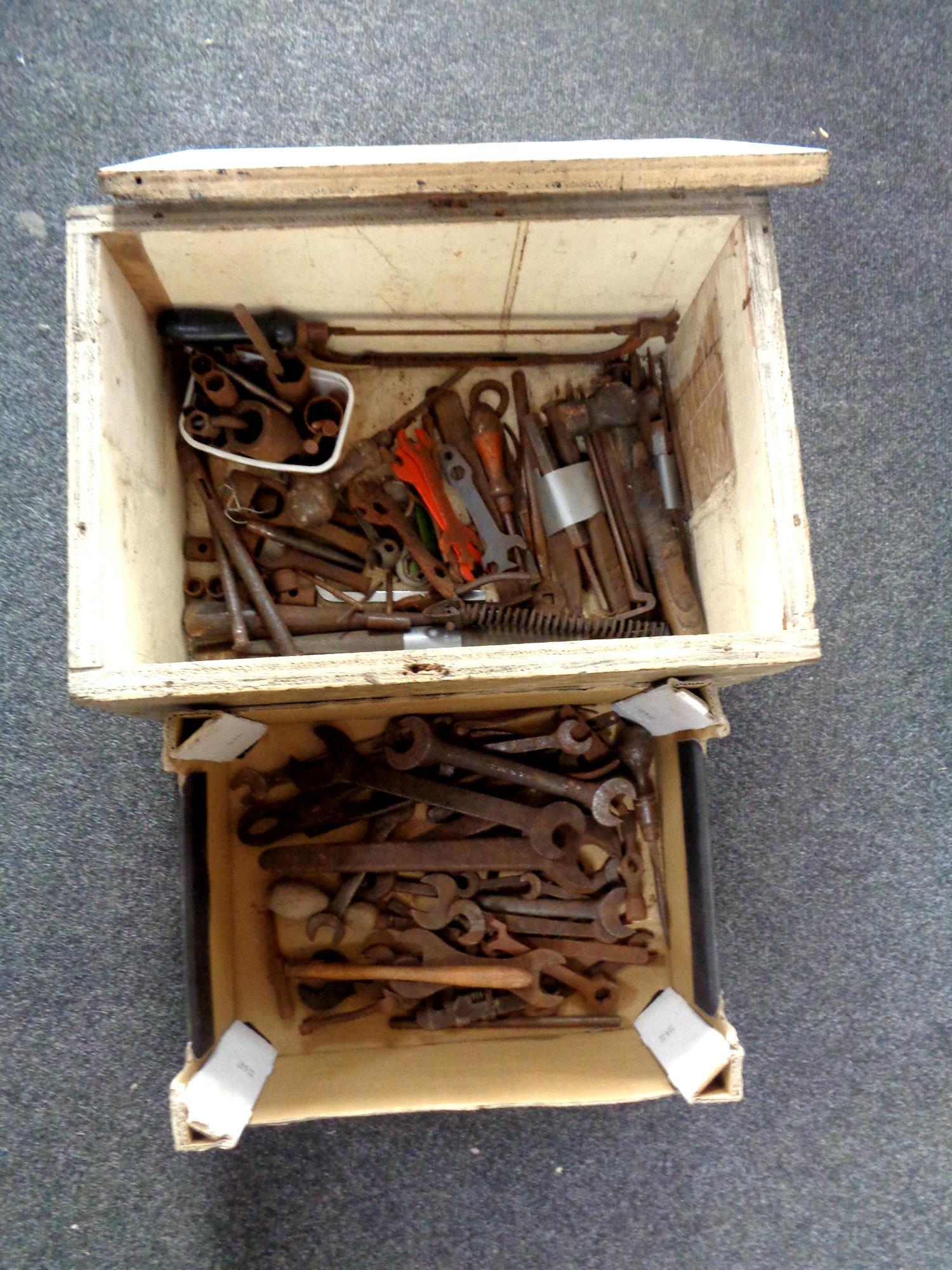 A painted crate and a box containing assorted hand tools to include ring spanners,