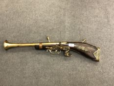 An ornamental brass and wood blunderbuss