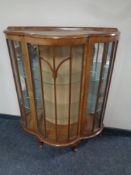 A 20th century shape front walnut display cabinet