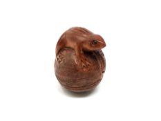 A carved hardwood Chinese netsuke - Frog on a fruit