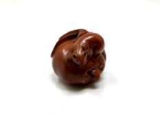 A carved hardwood Chinese netsuke - Two rats in a pumpkin