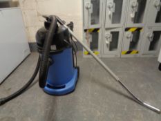 A Numatic commercial wash and dry vacuum with hose