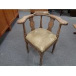 A 20th century carved oak corner chair