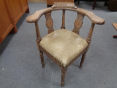 A 20th century carved oak corner chair