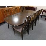 A 20th century Danish Farstrup twin pedestal extending dining table with two leaves together with a