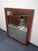 A contemporary leather framed mirror