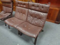 A pair of 20th century stained beech relaxer high back chairs with brown buttoned leather cushions