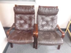 A pair of 20th century stained beech high back armchairs with brown buttoned leather cushions