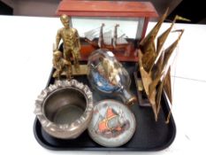 A tray containing brass figures, miners, a model of a ship in dimple whiskey bottle,