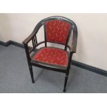 A 20th century ebonised beech armchair