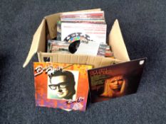 A box containing vinyl LPs and seven inch singles to include Barry Manilow, Buddy Holly,
