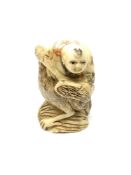 A carved bone Chinese netsuke - Man riding a large bird