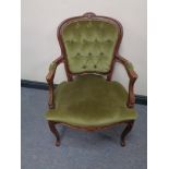 A beech framed salon armchair upholstered in a green button dralon