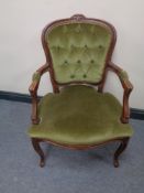 A beech framed salon armchair upholstered in a green button dralon