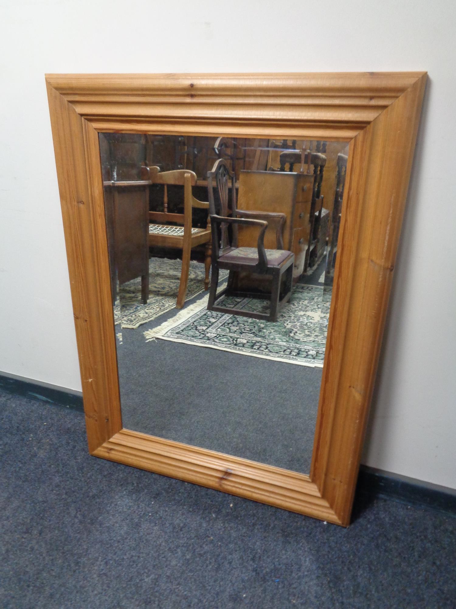 A contemporary pine framed bevel edged mirror
