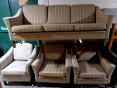 A 20th century continental three piece lounge suite upholstered in a brown striped fabric