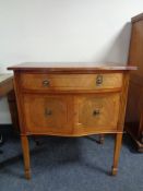 An inlaid mahogany double door cabinet fitted a drawer above on raised legs