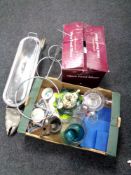 A boxed food slicer together with a stainless steel fish kettle box containing wine bottle stands,