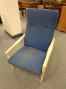 A wood framed high back armchair upholstered in a blue fabric