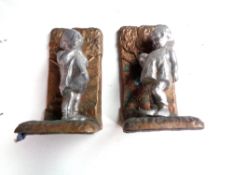 A pair of cast metal figural bookends modelled as children