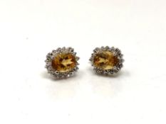 A pair of white gold citrine and diamond cluster earrings