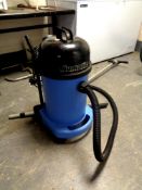 A Numatic commercial wash and dry vacuum with hose