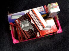 A box containing miscellaneous boxed items to include exterior flood lights, laminator,