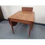 A mahogany flap sided dining table with two leaves