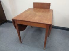 A mahogany flap sided dining table with two leaves